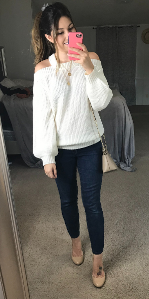 White off the shoulder sweater with jeans and nude heels 