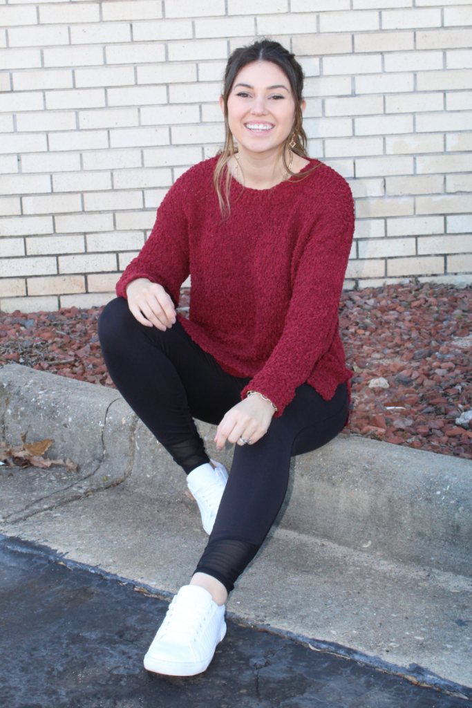 seated sweater with leggings and white sneakers 