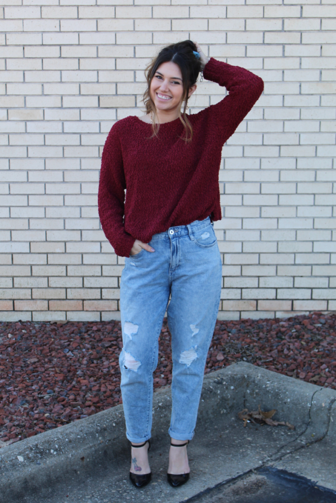 Red sweater tucked in and mom  jeans