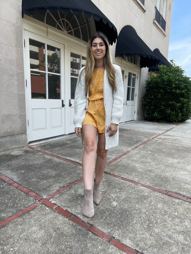 short yellow romper with boots and cardigan 