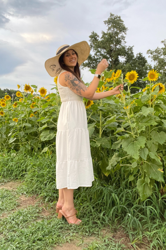 outfit to wear for a sunflower field photoshoot - me wearing a white dress with a floppy sun hat